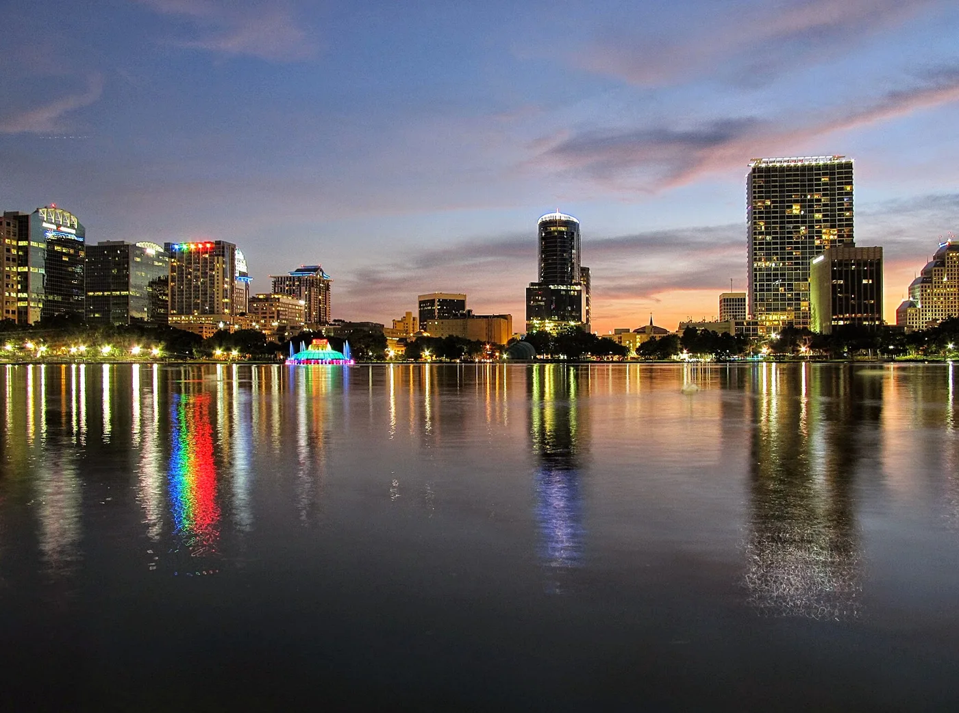 Lake Eola Park at dusk, with the downtown Orlando skyline across the water