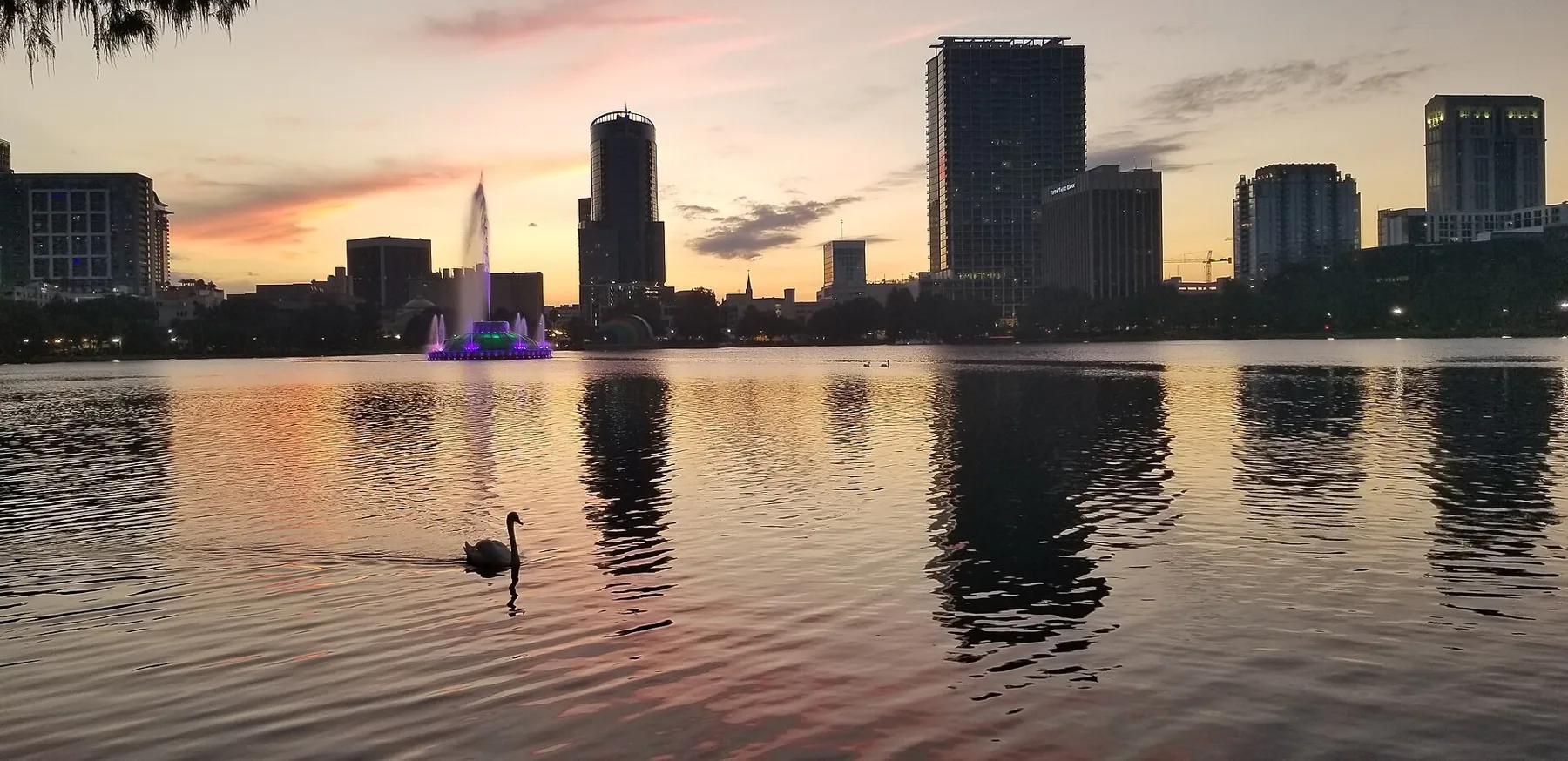 Sunset over Lake Eola in downtown Orlando, with the fountain at left