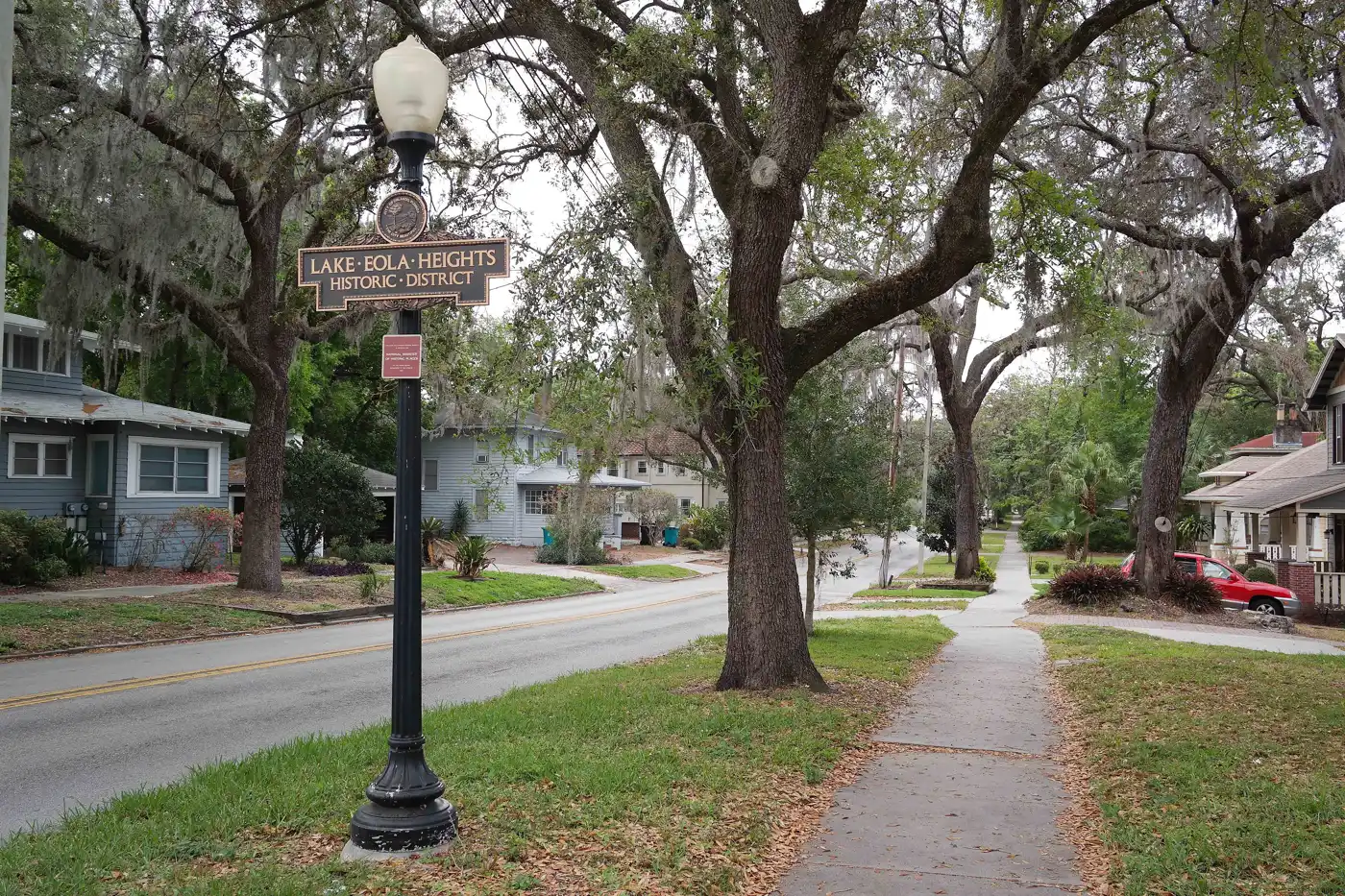 A Lake Eola Heights Historic District sign on a tree-lined street north of Lake Eola