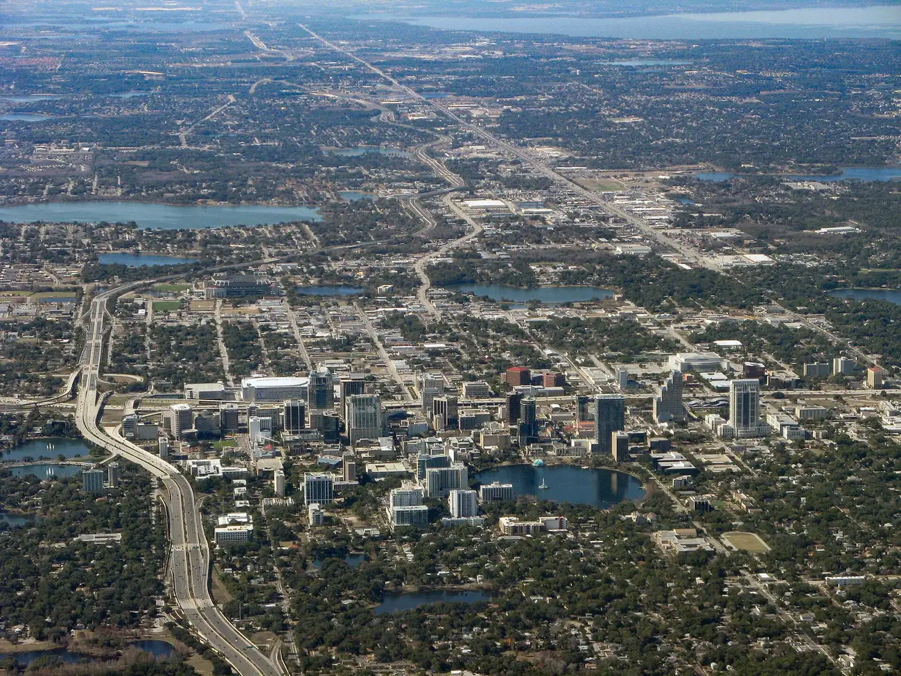 An aerial view of downtown Orlando and its lakes, with Interstate 4 curving through the city