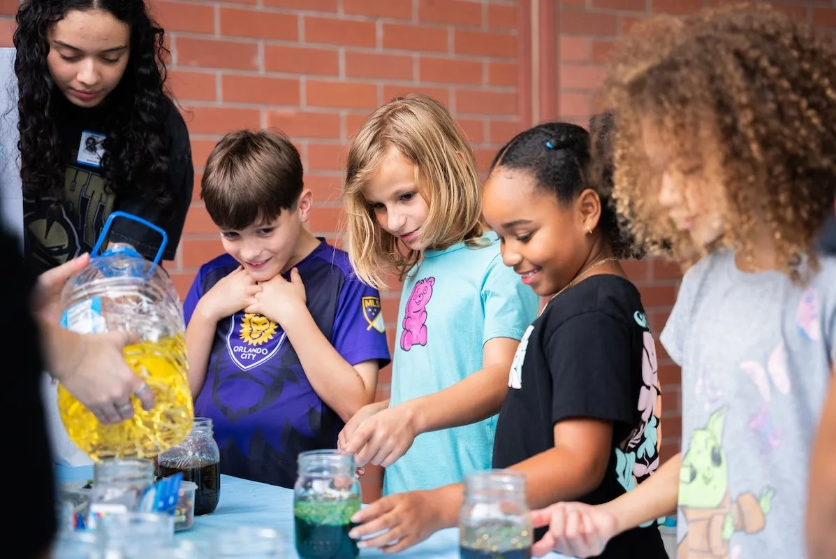 Children try a hands-on science activity in a photo UCF released with its Parramore Launch Pad announcement.